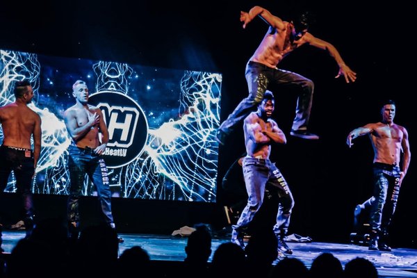 Aussie Heat dancers performing an energetic male revue routine in Las Vegas