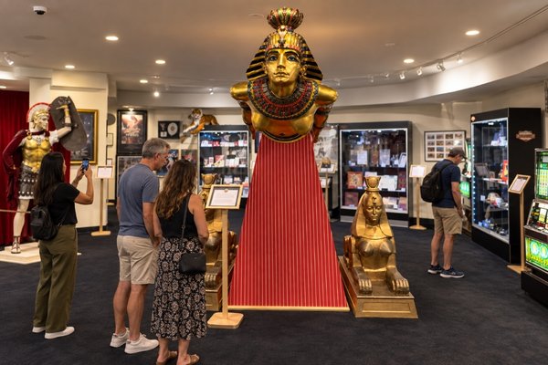 Visitors admire the golden Cleopatra display and historic memorabilia at the Caesars Palace 60th Anniversary Experience.