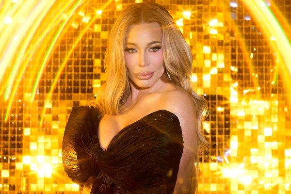 Taylor Dayne posing in front of a shimmering gold backdrop for her Las Vegas residency