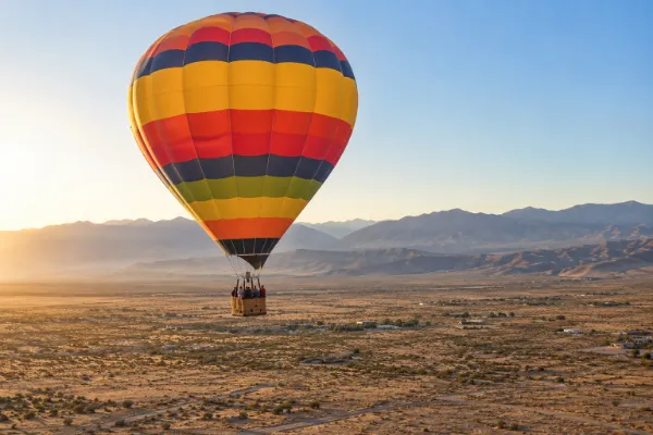 Hot air balloon flying above Pahrump Valley near Las Vegas at sunrise