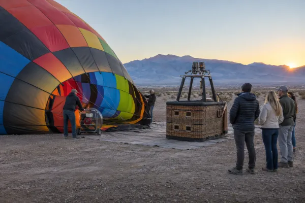 Crew preparing a hot air balloon for a sunrise flight in Pahrump Valley