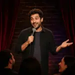 Stand-up comedian performing under a spotlight at an intimate Las Vegas comedy club