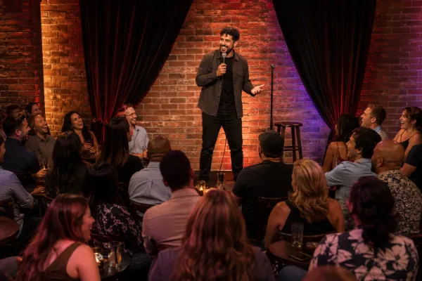 Stand-up comedian performing for a laughing audience at an intimate Downtown Las Vegas comedy club