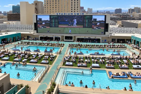 Tiered pools facing the sports screen at Stadium Swim at Circa in Downtown Las Vegas.