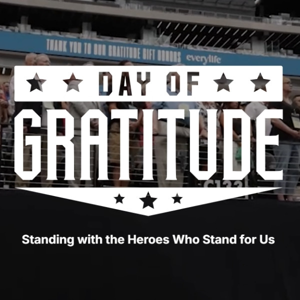 Day of Gratitude logo over a stadium crowd with the message “Standing with the Heroes Who Stand for Us.”