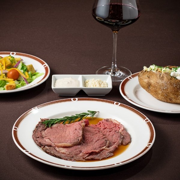 Prime rib dinner with a baked potato, salad and red wine at Primarily Prime Rib at South Point