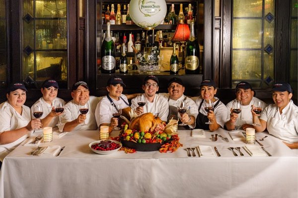Mon Ami Gabi culinary team gathered around a Thanksgiving turkey dinner in Las Vegas