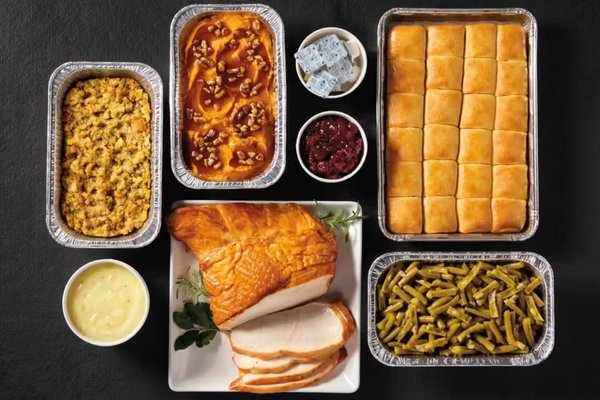 Cracker Barrel Thanksgiving Family Dinner with turkey breast, cornbread dressing, gravy, cranberry relish, sweet potato casserole and rolls.