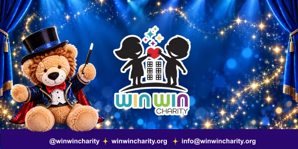 Win Win Charity logo and a stuffed lion dressed as a magician against a blue stage backdrop.
