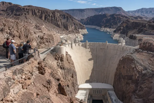 Visitors overlook Hoover Dam and Black Canyon while exploring Southern Nevada engineering history for Nevada Day.