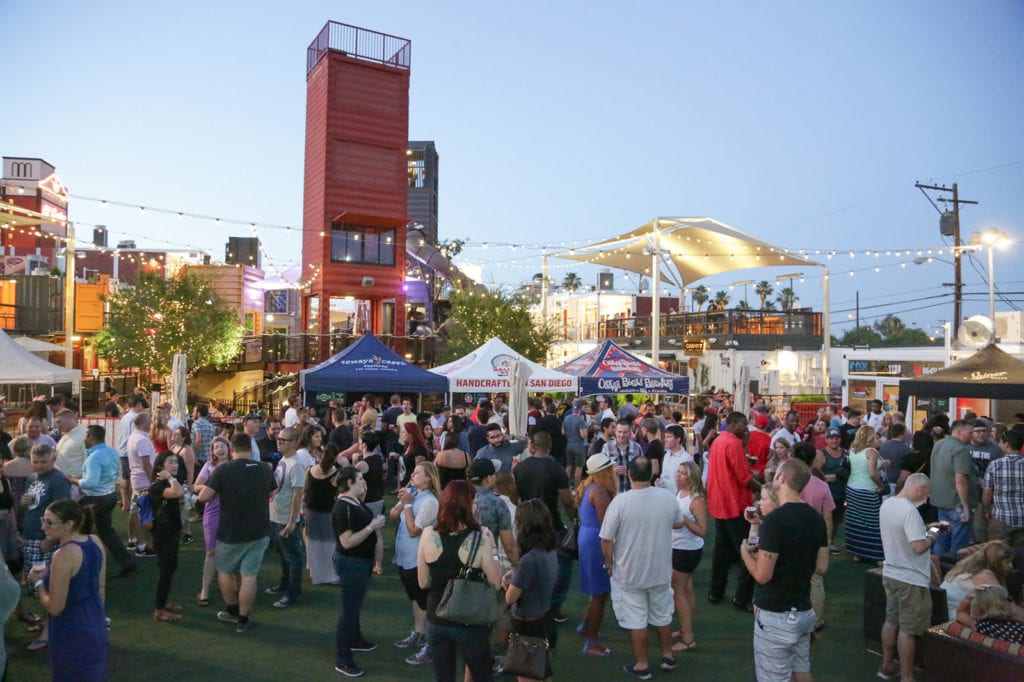 A crowd of people gather around vendor stalls at a beer festival at the Downtown Container Park in Las Vegas